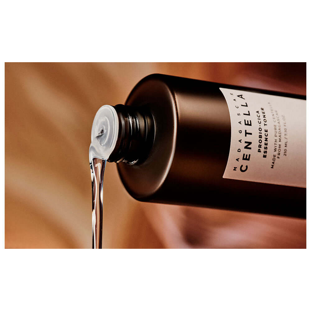 Skin1004 Madagascar Centella Probio-Cica Essence Toner pouring from bottle, showcasing its watery texture.
