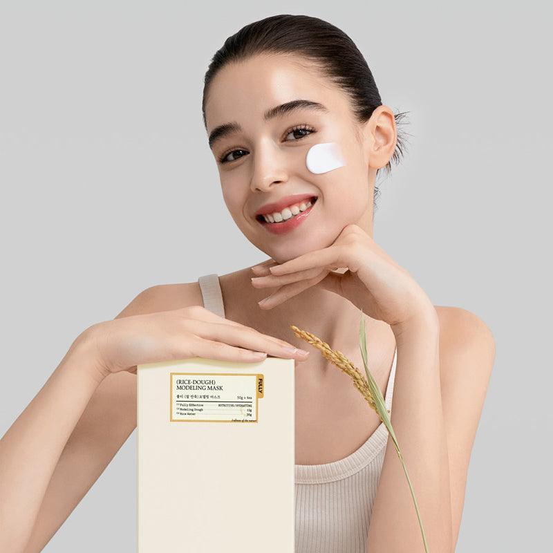 Smiling woman applying FULLY Rice Dough Modeling Mask for soothing hydration and glowing skin.