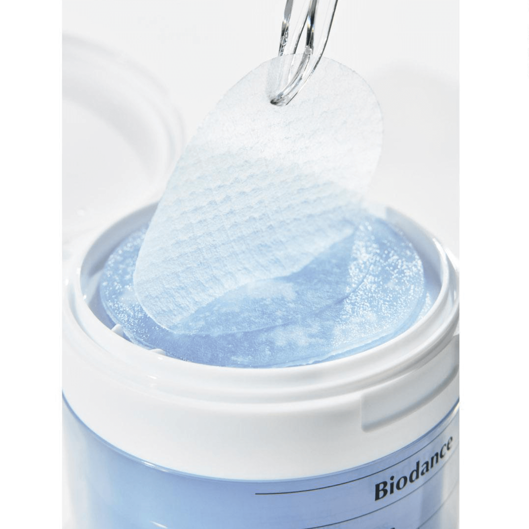 Biodance Cera-nol Gel Toner Pads being lifted from the container, designed for soothing and moisturizing sensitive skin.