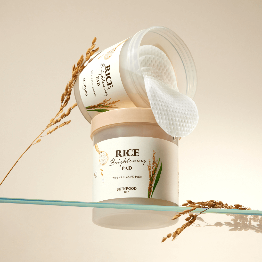 SKINFOOD Rice Brightening Pad jar with pads, infused with PHA for a clear, moisturized complexion, ideal for all skin types.