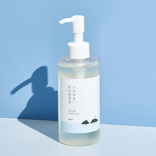 Round Lab Dokdo Cleansing Oil 200ml in a clear bottle with pump on a blue background.